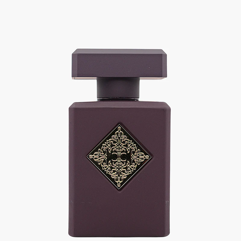Purple perfume bottle with decorative gold emblem on a white background