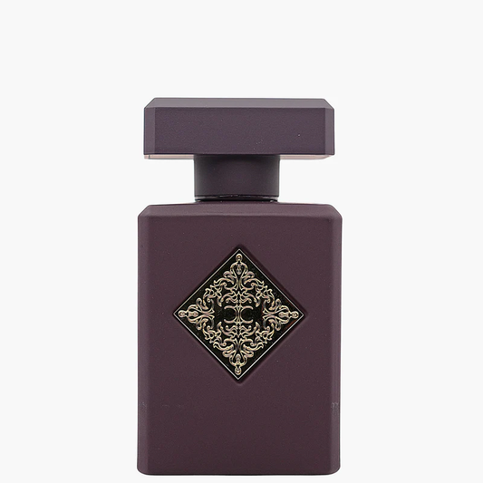 Purple perfume bottle with decorative gold emblem on a white background